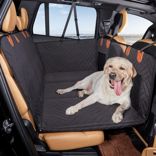Happy Labrador dog lying on the Pawsely Pup-tastic Car Backseat Cover & Extender with hard bottom.
